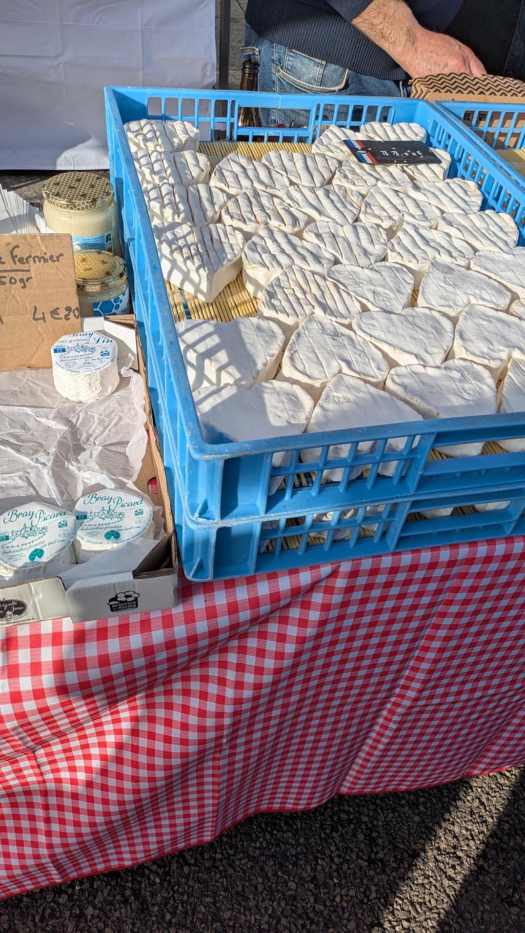 Norman soft cheeses displayed at a farmer's market